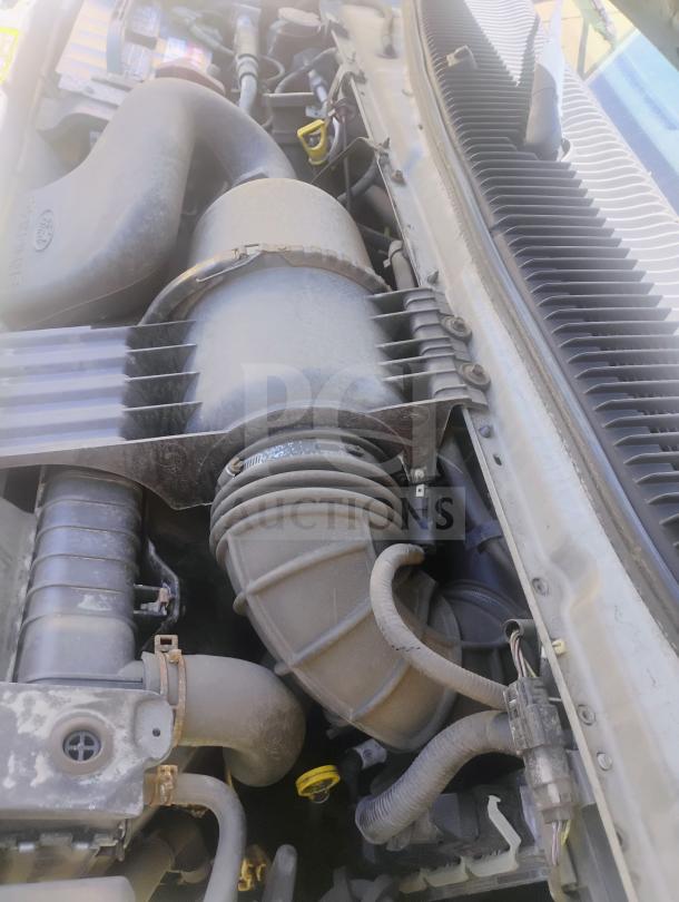 Engine bay of a 2010 Ford E350 Commercial Cargo Van, showing hoses and components. Odometer: 162,472 miles.
