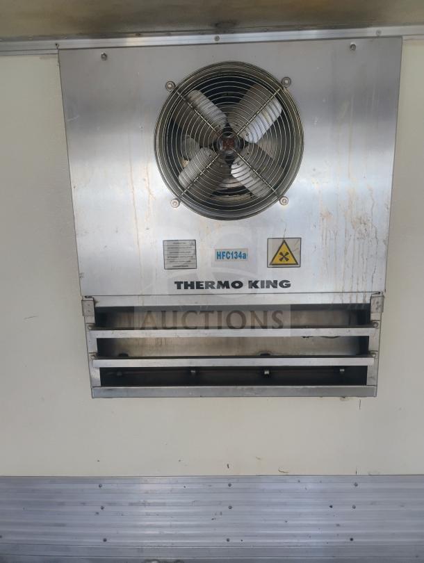 Thermo King rooftop reefer unit in a UD International cab-over refrigerated truck, marked HFC134a.
