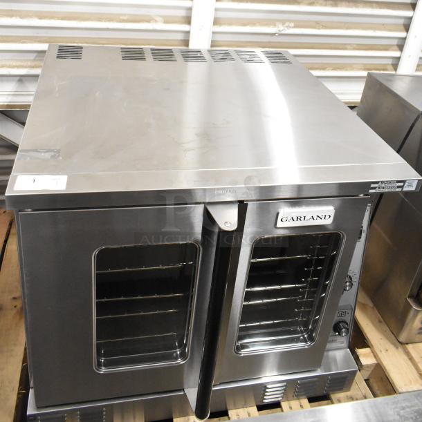 Brand new Garland MCO-GS-10S stainless steel convection oven, 60,000 BTU, view-through doors, metal racks, thermostatic controls.