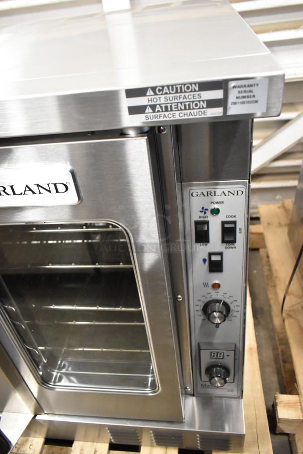 Brand new Garland MCO-GS-10S stainless steel commercial convection oven, scratch and dent, with view-through doors, racks, and controls.