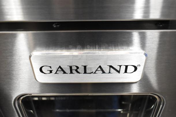 Brand new Garland MCO-GS-10S convection oven, stainless steel, view-through doors, 60,000 BTU, metal racks, thermostatic controls.
