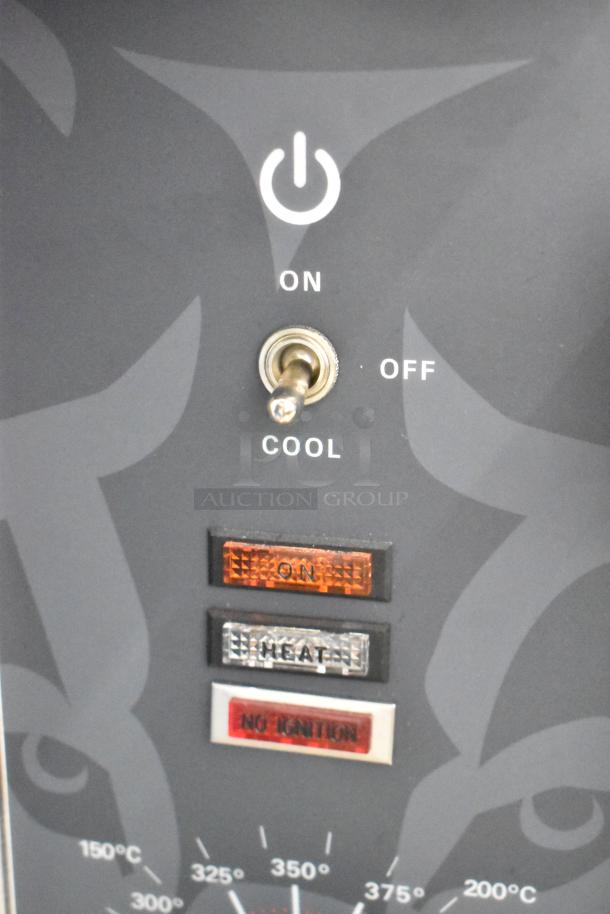 Close-up of control panel on Wolf WC4GD-11D3 stainless steel convection oven showing power switch and indicator lights.