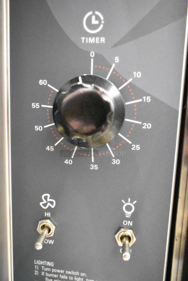 Wolf WC4GD-11D3 convection oven controls with timer dial, fan, and light switches. Stainless steel, natural gas-powered.