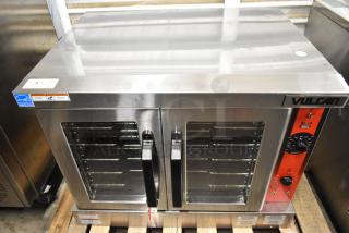 Brand new Vulcan stainless steel commercial convection oven, features view-through doors, metal racks, thermostatic controls.