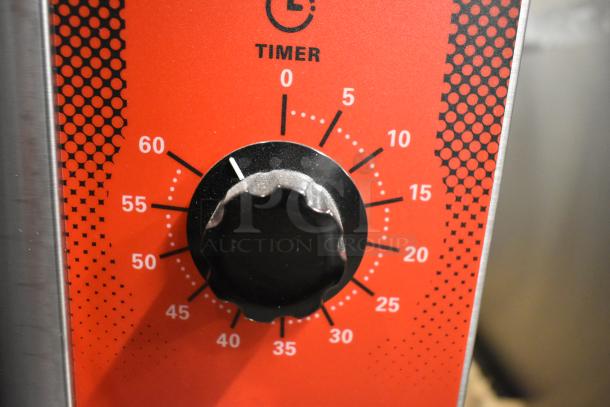 Timer dial on a Vulcan convection oven showing minutes, red background, black knob.