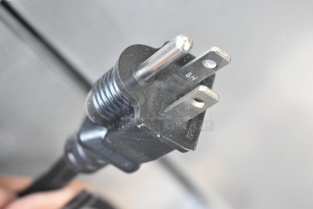 Close-up of a black electrical plug. No branding or specific markings related to the Vulcan oven are visible.