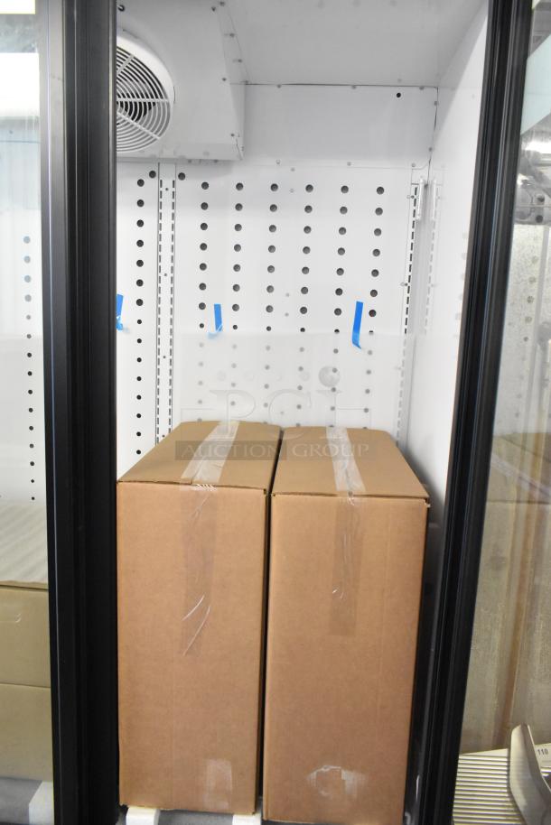 True FLM-81 Metal 3 Door Reach-In Cooler, brand new scratch and dent, 115V, 1 Phase, interior view with cartons.