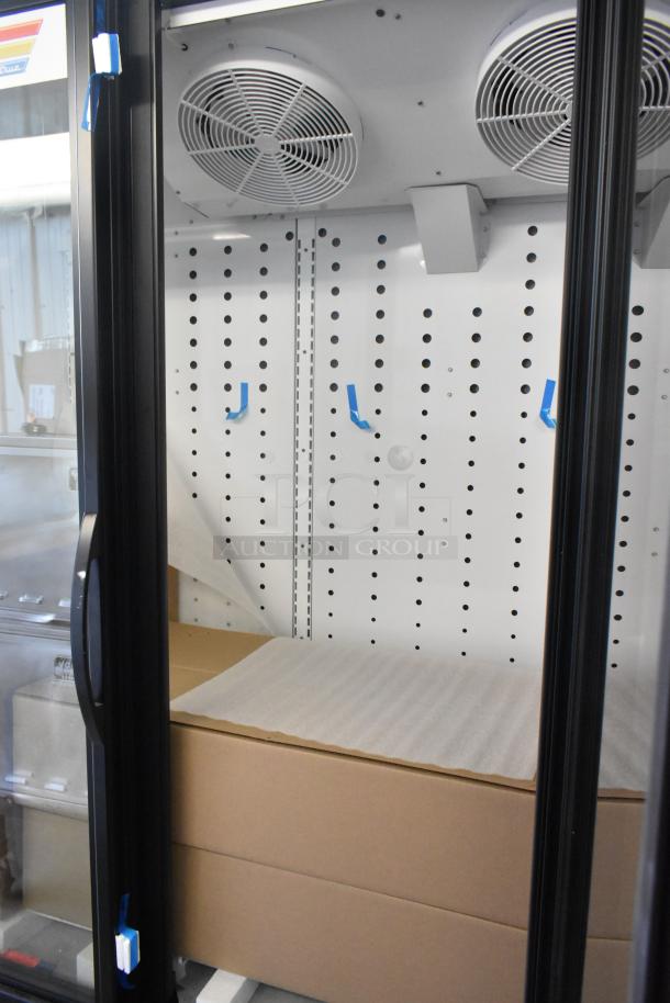 Brand new 2025 True FLM-81 metal 3-door cooler, scratch and dent, 115 volts, 1 phase, interior view, label visible.