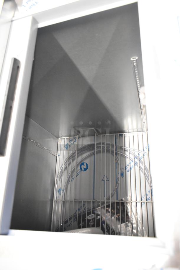 Beverage Air DD68HC-1-C-B kegerator interior, stainless steel, with tubing and shelves, new condition, scratches visible.