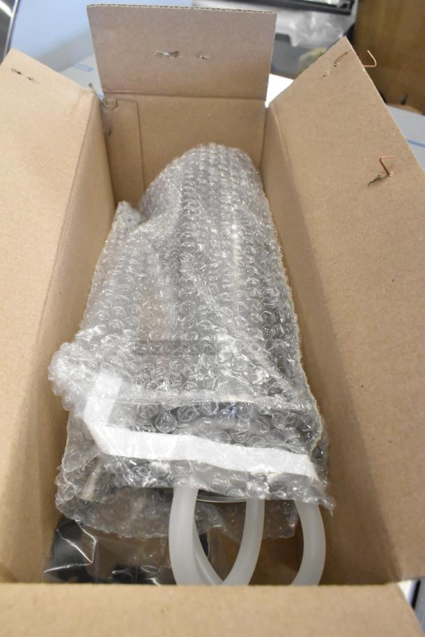 Cardboard box containing a kegerator tap kit wrapped in bubble wrap, showing clear hoses and packaging materials.
