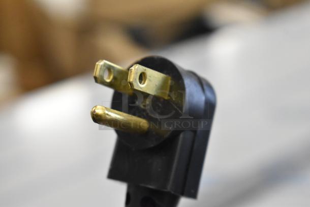 Close-up of a standard three-prong electrical plug, compatible with Beverage Air DD68HC-1-C-B kegerator.