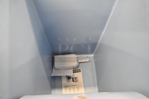 Brand new Avantco 194BIN40022 Stainless Steel Ice Storage Bin, 383 lb capacity, interior view showing manual and scoop.