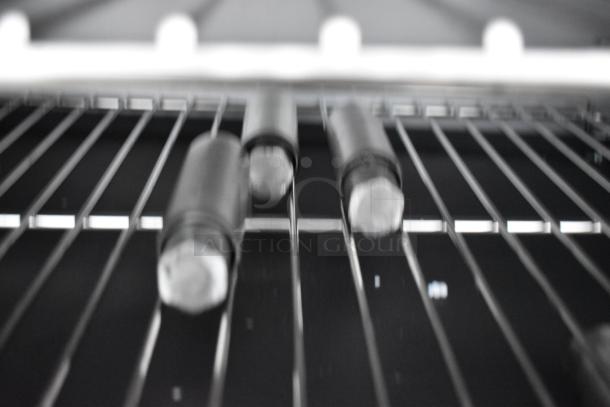 Interior of the Cooking Performance Group S36-L 351S36L range, showing metal grates and burner caps, designed for commercial use.