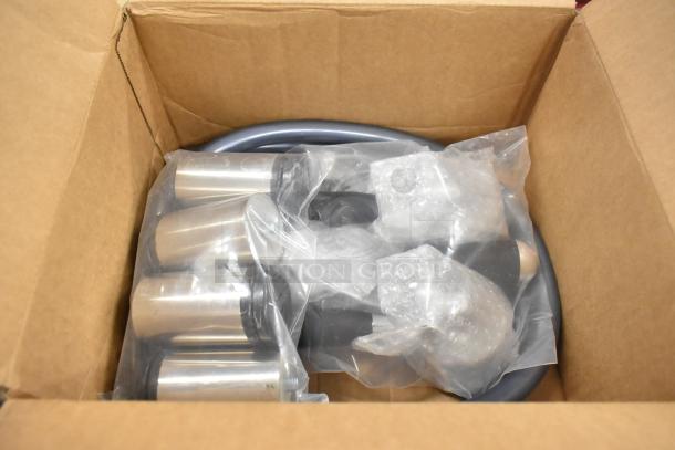 Box containing components of a new Astra M2 012 commercial espresso machine, wrapped in protective packaging.