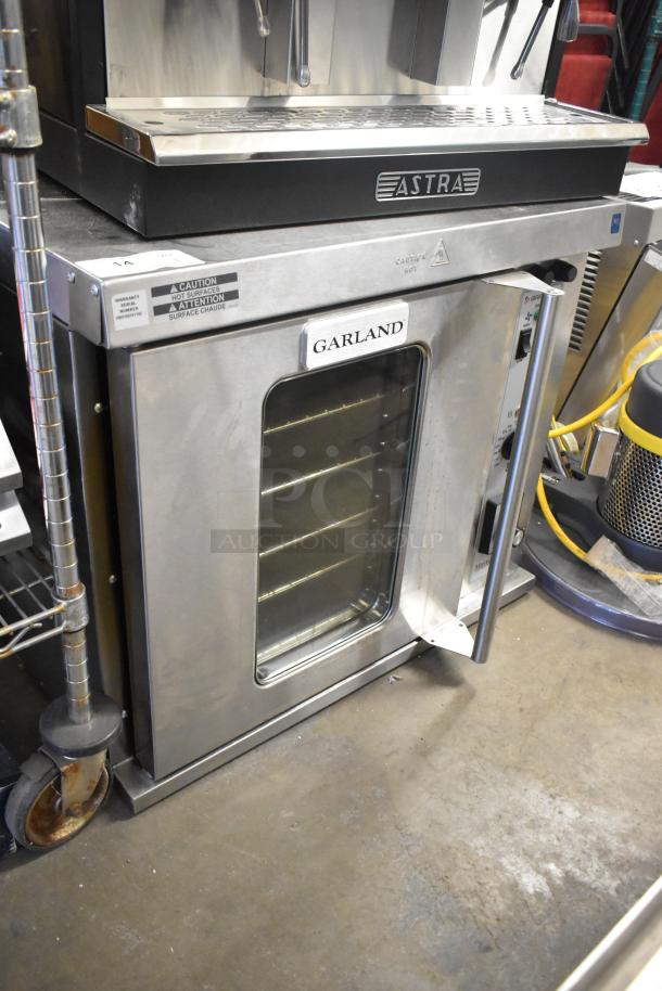 Garland Master 200 stainless steel half-size convection oven, view-through door, metal racks, thermostatic controls.