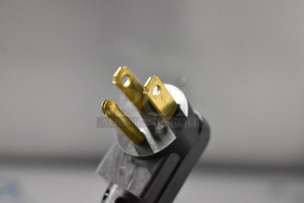 Close-up of a power plug for a Beverage Air BB72HC-1-GS-B-27 commercial cooler, 115 volts, visible prongs.