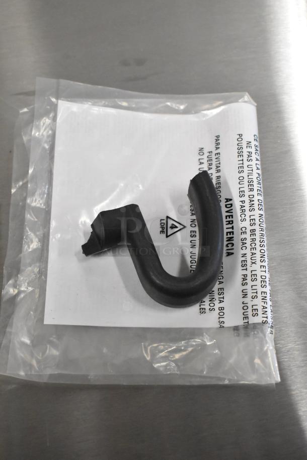 Alt text: Plastic hook on packaging with label warnings in multiple languages.