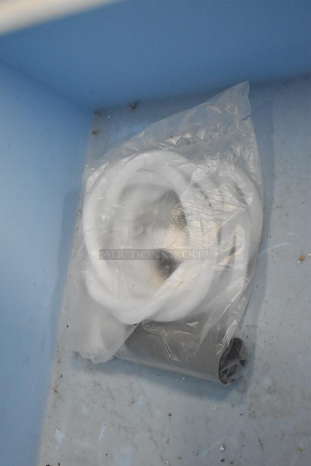 Brand new Hoshizaki B-900SF ice storage bin interior, showing included accessories in plastic bag. Holds 900 lbs, stainless steel.