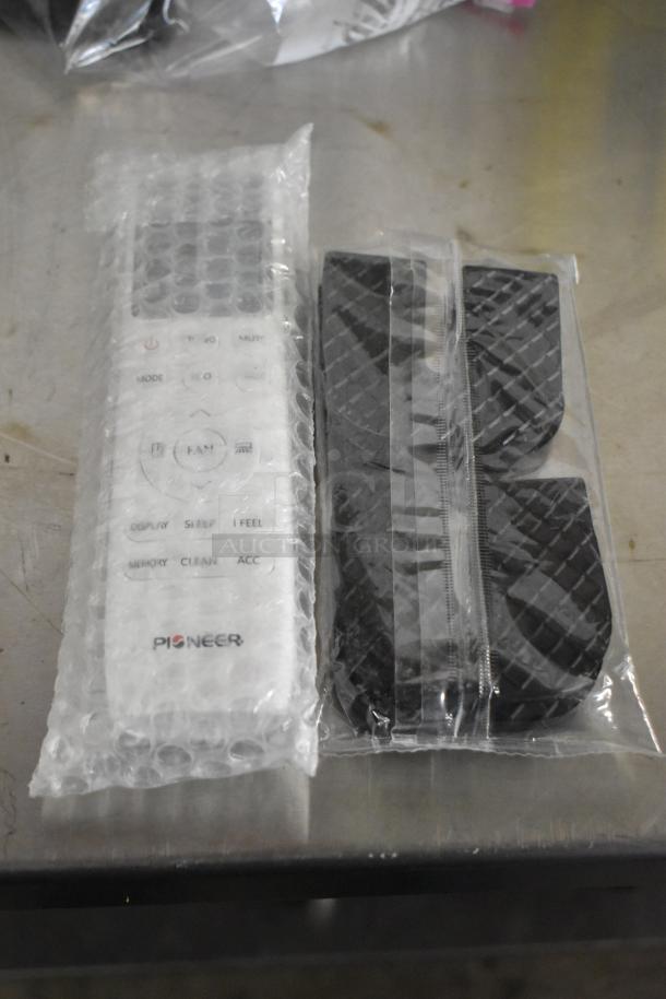 Pioneer WT018GLSI25HLH air curtain remote in bubble wrap with controls visible.