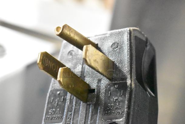 Close-up of power plug for Cooking Performance Group 36" 6-burner range, showing prongs and voltage markings.