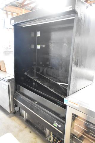 Turbo Air TOM-50B-SP-A-N metal commercial merchandiser, black, 115V, 1 phase. Some wear visible, Turbo Air label present.