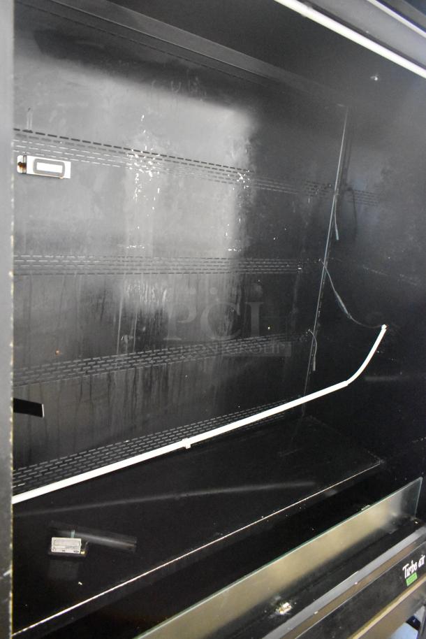 Turbo Air TOM-50B-SP-A-N metal commercial merchandiser, black interior, 115 volts, some wear, open design for easy access.