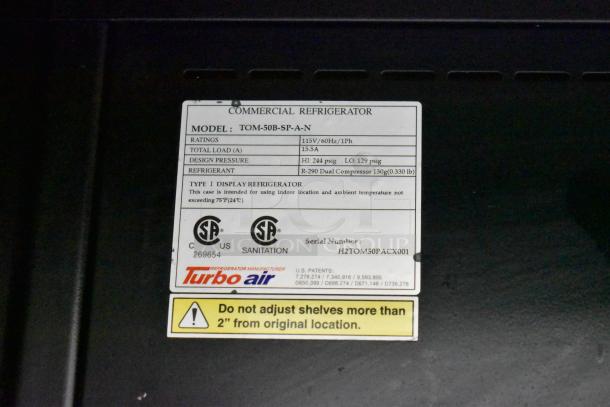 Turbo Air TOM-50B-SP-A-N display with specs tag showing model, 115V/60Hz, 15.5A, and refrigerant info.