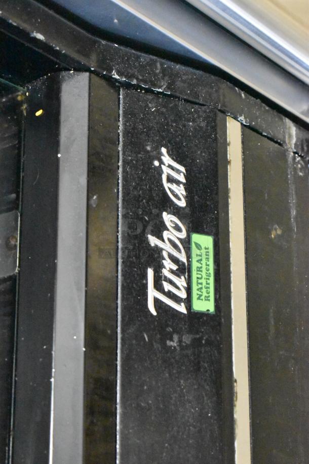 Turbo Air reach-in merchandiser, TOM-50B-SP-A-N model, black metal, natural refrigerant label, 115V, 1 phase.