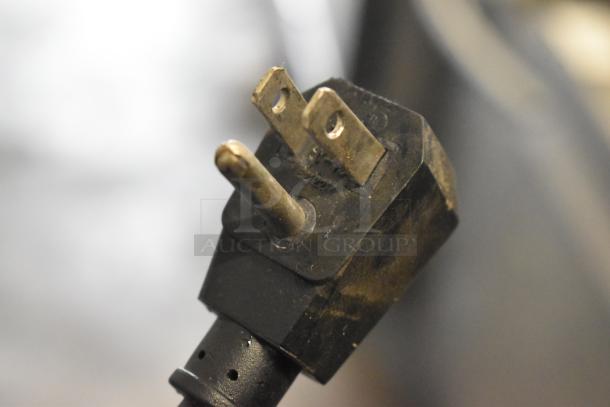 A close-up of a standard electrical plug for the Avantco 178SSWT48FHC cooler, showing two flat and one round prong.