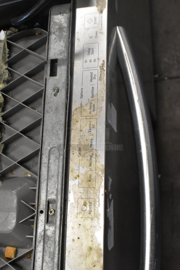 Samsung DW80M2020US stainless steel dishwasher, visible control panel with options and cycles, signs of wear and residue.