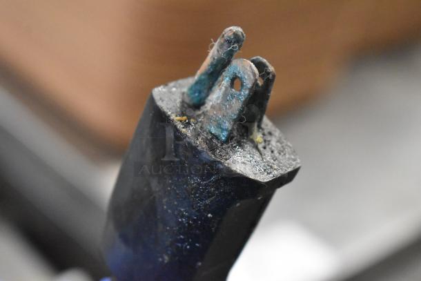 Close-up of a corroded and worn electrical plug, likely from the Samsung DW80M2020US dishwasher. Pin corrosion visible.