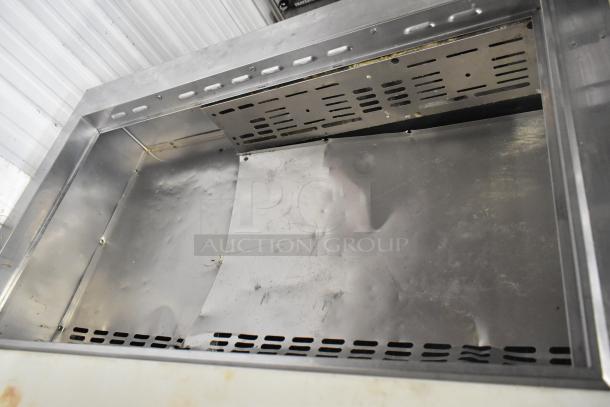 Turbo Air MST-72-30-N stainless steel prep table, commercial casters, and 115V, 1 phase power. Interior view, used condition.