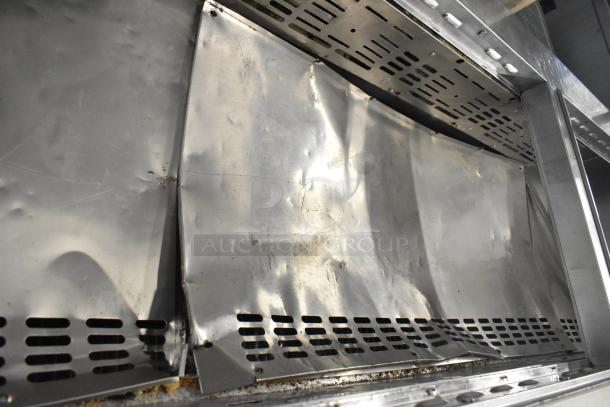 Turbo Air MST-72-30-N prep table with damaged stainless steel surface, visible dents, and scratches; commercial casters included.