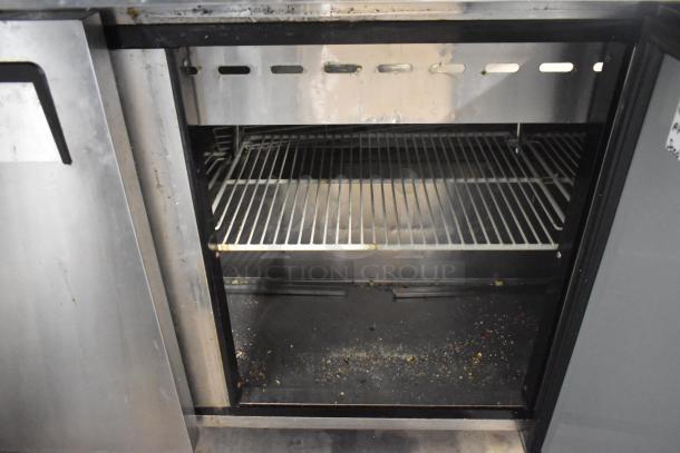 Turbo Air MST-72-30-N stainless steel prep table interior. Features commercial casters, visible wear, operates on 115 volts, 1 phase.