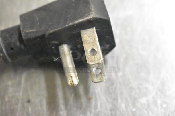 Close-up of a plug from the Turbo Air MUF-36-N undercounter freezer. The plug shows wear, indicating use.