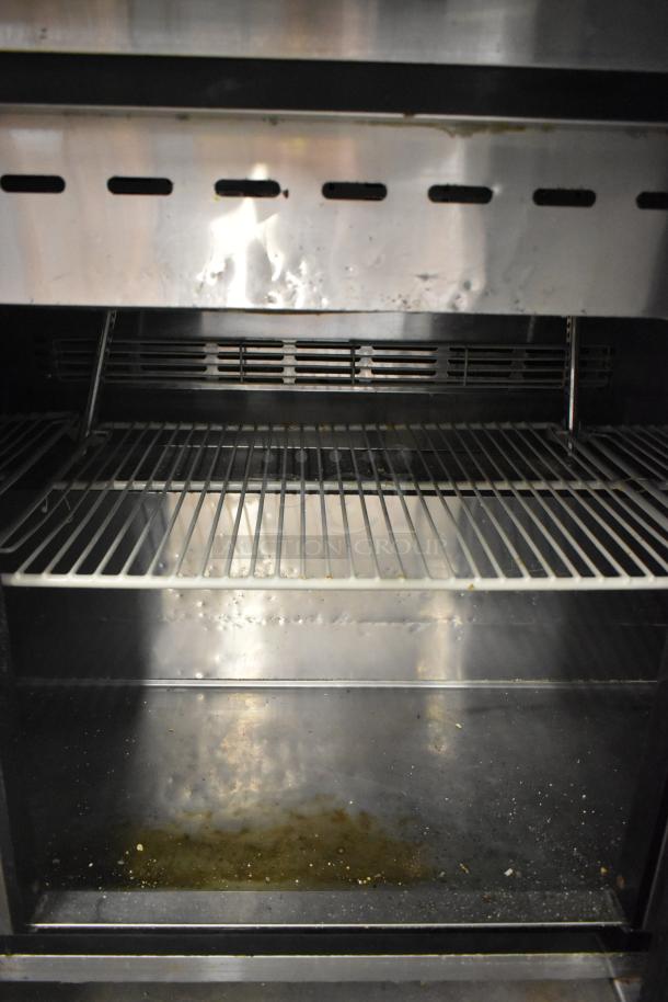 Turbo Air TWR-72SD-N commercial prep table, stainless steel interior, visible casters, 115V, 1 phase, used condition.