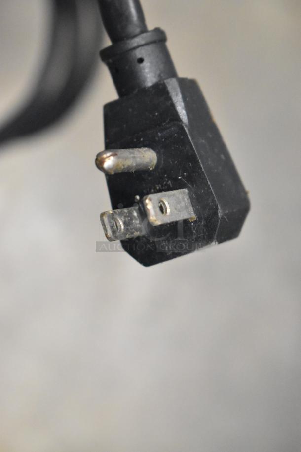 Close-up of a two-prong plug from the Turbo Air TWR-72SD-N commercial prep table, showing slight wear.