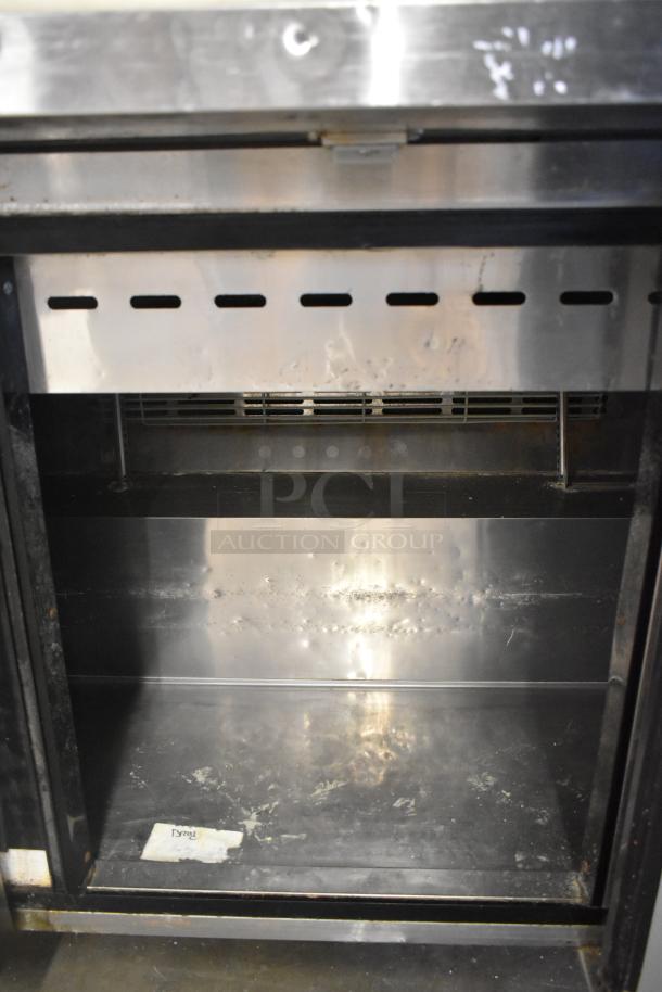 Turbo Air MST-72-30-N stainless steel sandwich salad prep table, interior view, on commercial casters. Model TWR-72SD-N.