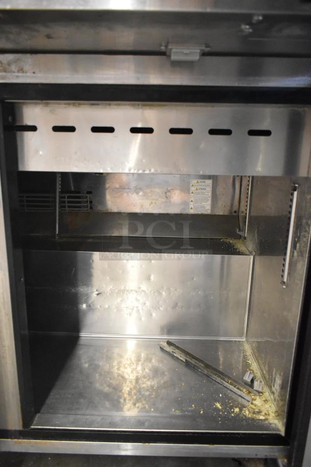 Turbo Air MST-72-30-N stainless steel prep table interior with commercial casters, 115V, visible condition details.