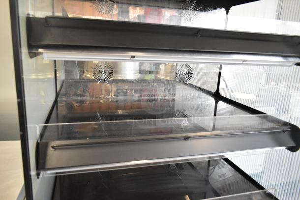 2024 Flexeserve FXZNA10S4S-ST61 heated merchandiser. Metal, floor-style, reach-in shelves. 208V, 1-phase. Clean condition.