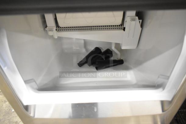 BRAND NEW 2024 Hoshizaki KM-81BAJ stainless steel ice maker interior, showing ice compartment and components. 115V, 1 phase.