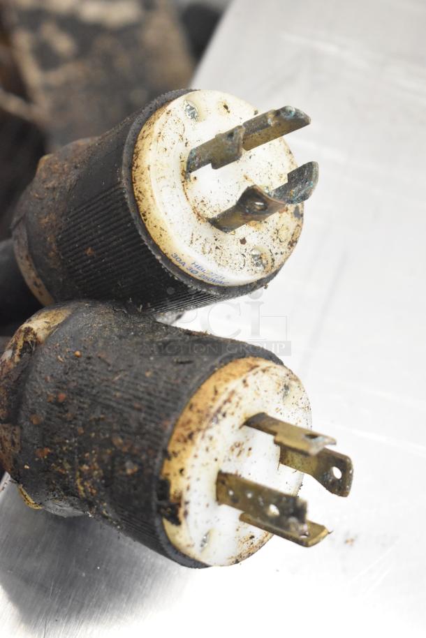 Two 208V electric plugs, slightly rusted and worn, attached to Middleby Marshall CTX DZ33I conveyor pizza ovens.