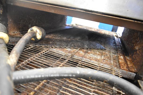 Interior of 2021 Middleby Marshall CTX DZ33I conveyor pizza oven, showing wire conveyor belt and components, in used condition.