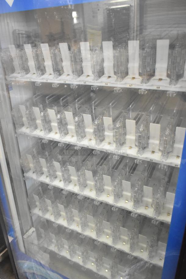 Crane 5800-4 metal commercial bottled drink vending machine with bill acceptor. Features multiple clear product slots.