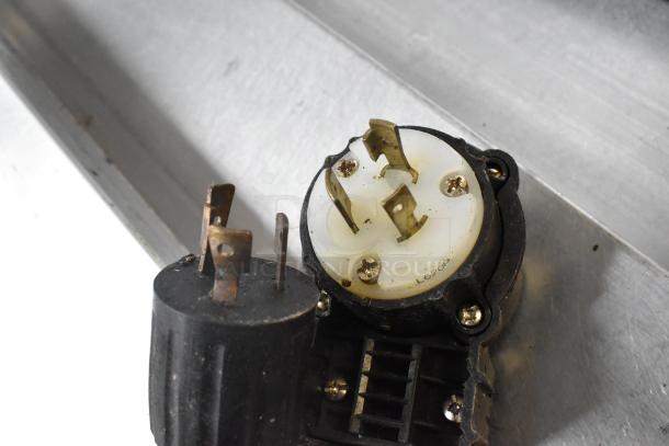 Close-up of a plug with a visible L6-20P marking on a Middleby Marshall PS638G pizza oven.