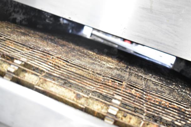 Two 2021 Middleby Marshall PS638G stainless steel conveyor pizza ovens, natural gas powered, on commercial casters.