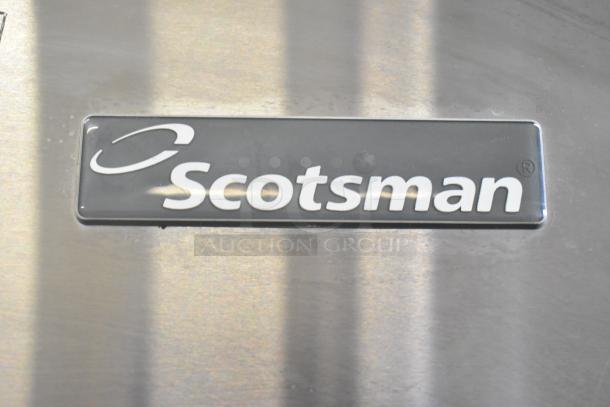 Scotsman CME656AS-32F ice machine logo on stainless steel surface. 208/230V, 1 phase.