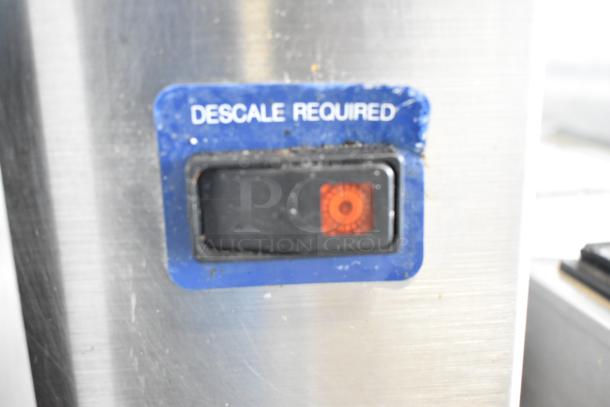 Cleveland SteamCraft Ultra 10 steam cabinet descale indicator light on stainless steel surface.