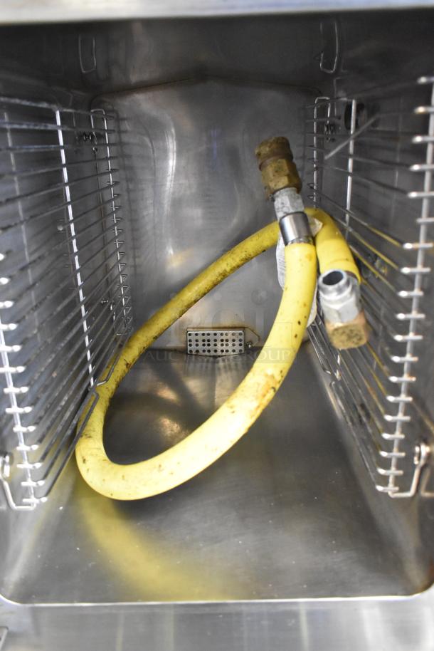 Cleveland SteamCraft Ultra 10 stainless steel steam cabinet interior with yellow hose, showcasing durable construction.