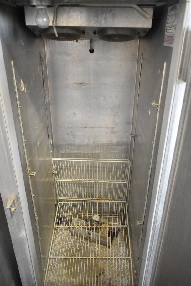 Continental 1FE stainless steel commercial single door reach-in freezer interior, showing shelves and some wear. 115 volts, 1 phase.
